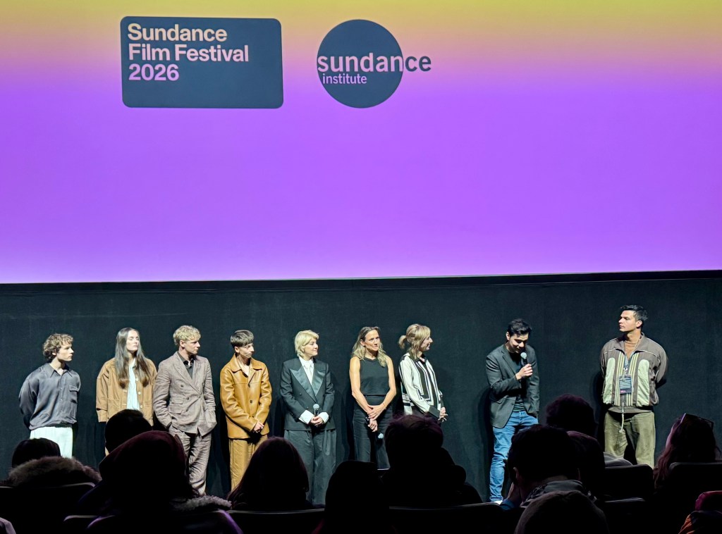 Panel of filmmakers and actors on stage at the Sundance Film Festival 2026, with a colorful background displaying the festival logo.